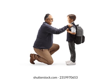 Full length profile shot of a grandfather helping a boy getting ready for school isolated on white background - Powered by Shutterstock