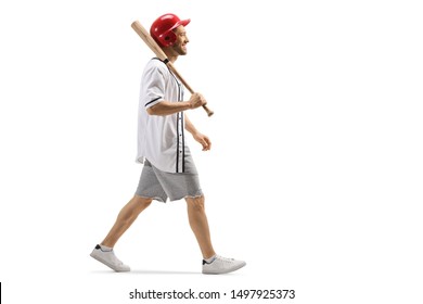 Full length profile shot of a guy walking with a baseball bat and a helmet isolated on white background - Powered by Shutterstock