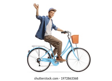 Full length profile shot of a guy riding a city bicycle and waving at camera isolated on white background
