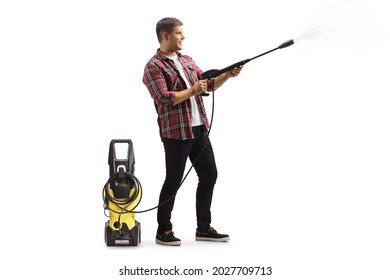 Full Length Profile Shot Of A Guy Using A Pressure Washer Machine Isolated On White Background