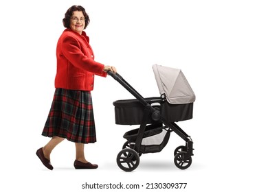 Full Length Profile Shot Of A Happy Elderly Woman Walking And Pushing A Baby Stroller Isolated On White Background