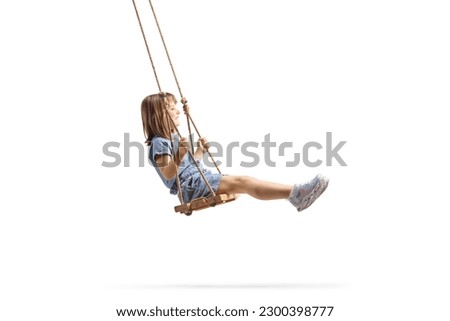 Full length profile shot of a happy little girl swinging on a wooden swing isolated on white background Stock foto © 