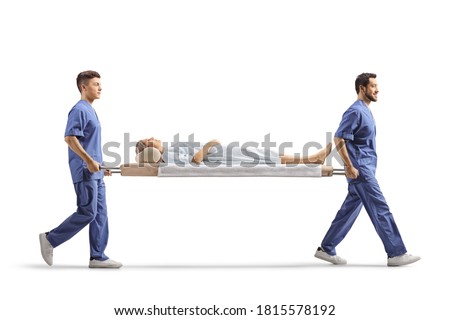 Full length profile shot of healthcare workers carrying a female patient on a stretcher isolated on white background Foto d'archivio © 