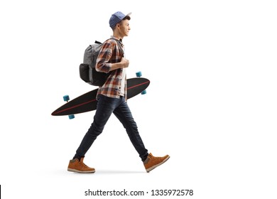 Full length profile shot of a male student walking and holding a longboard isolated on white background
 - Powered by Shutterstock