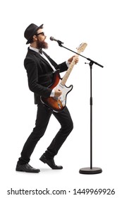 Full Length Profile Shot Of A Male Artist Playing A Bass Guitar And Singing On A Mic Isolated On White Background