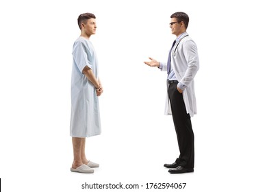 Full Length Profile Shot Of A Male Doctor Talking To A Young Male Patient Isolated On White Background