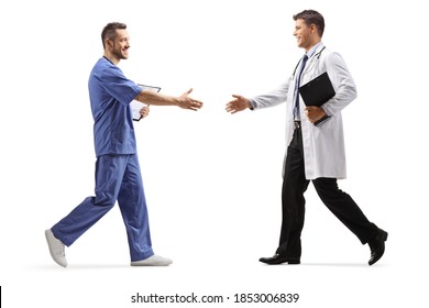 Full Length Profile Shot Of A Male Health Worker Greeting A Doctor Isolated On White Background