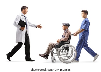 Full Length Profile Shot Of A Male Doctor Greeting Elderly Patient In A Wheelchair Isolated On White Background