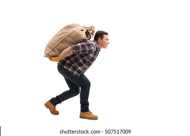 Full length profile shot of a male agricultural worker carrying a burlap sack on his back isolated on white background