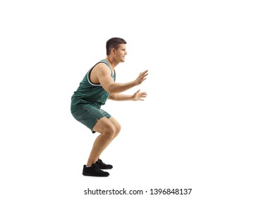 Full Length Profile Shot Of A Man Playing Defence In Basketball Isolated On White Background