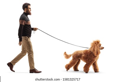 Full Length Profile Shot Of A Man Walking A Red Poodle Dog Isolated On White Background