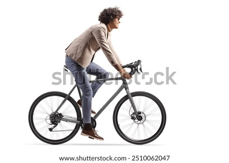 Full length profile shot of a man in suit riding a bicycle isolated on white background