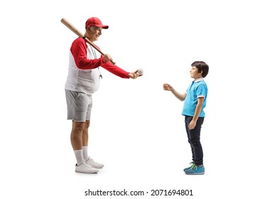 Full Length Profile Shot Of A Mature Man With A Baseball Bat Giving A Ball To A Boy Isolated On White Background