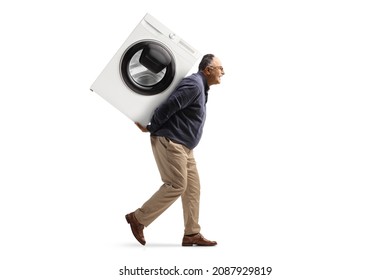 Full length profile shot of a mature man carrying a washing machine on his back isolated on white background - Powered by Shutterstock