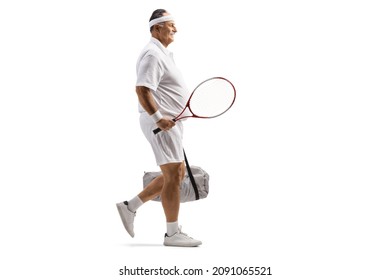 Full length profile shot of a mature male tennis player walking with a sports bag isolated on white background - Powered by Shutterstock