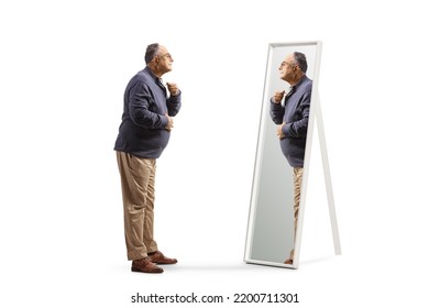 Full Length Profile Shot Of A Mature Man Getting Ready And Looking At A Mirror Isolated On White Background