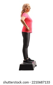 Full Length Profile Shot Of A Mature Woman Standing On An Aerobic Stepper Isolated On White Background