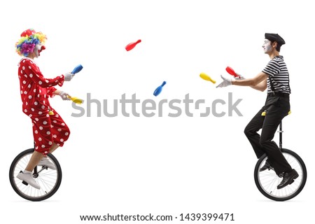 Full length profile shot of a mime and a clown on unicycles juggling with clubs isolated on white background