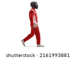 Full length profile shot of a racer in a red suit and black helmet walking isolated on white background