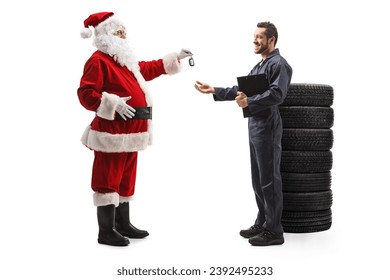 Full length profile shot of santa claus giving car keys to a mechanic isolated on white background - Powered by Shutterstock