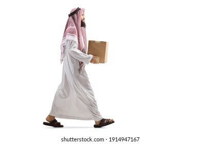 Full Length Profile Shot Of A Saudi Arab Man Walking With A Cardboard Box Isolated On White Background