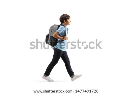 Full length profile shot of a schoolboy with a backpack walking isolated on white background