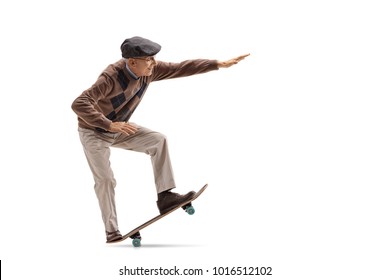 Full length profile shot of a senior riding a skateboard and doing a manual isolated on white background