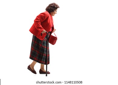 Full Length Profile Shot Of A Senior Lady In A Red Suit Walking With A Cane Isolated On White Background