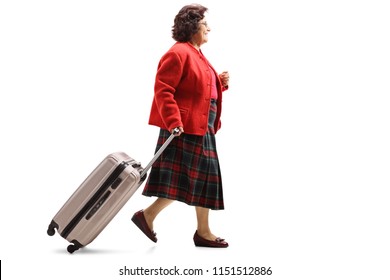 Full Length Profile Shot Of A Senior Lady Walking And Pulling A Suitcase Isolated On White Background