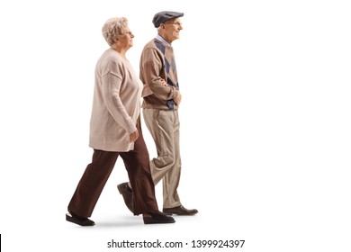 Full Length Profile Shot Of A Senior Husband And Wife Walking Isolated On White Background