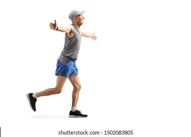 Full length profile shot of a senior man running and spreading arms isolated on white background - Shutterstock ID 1502083805