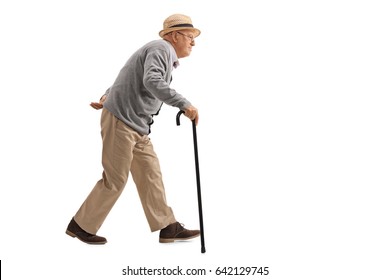 Full Length Profile Shot Of A Senior Walking With A Cane Isolated On White Background