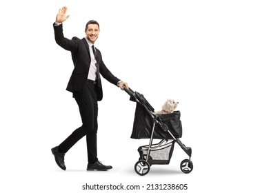 Full Length Profile Shot Of A Smiling Man In A Suit And Tie Pushing A Dog Stroller And Waving Isolated On White Background