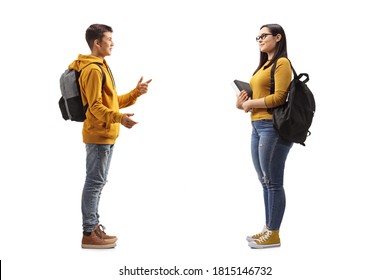 Full Length Profile Shot Of A Teenager Talking To An Older Female Student Isolated On White Background