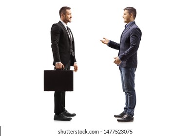 Full Length Profile Shot Of Two Young Men Talking Isolated On White Background