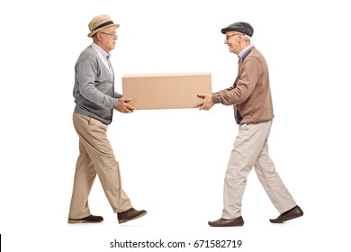 Full Length Profile Shot Of Two Mature Men Carrying A Big Cardboard Box Isolated On White Background