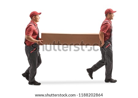 Full length profile shot of two movers carrying a big cardboard box isolated on white background