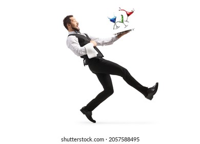 Full length profile shot of a waiter falling with a tray of cocktails isolated on white background