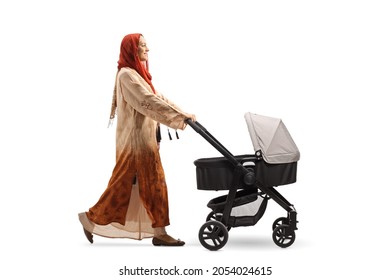 Full Length Profile Shot Of A Woman Wearing A Hijab And Pushing A Baby Stroller Isolated On White Background