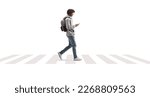 Full length profile shot of a young african american man using a phone and crossing street isolated on white background