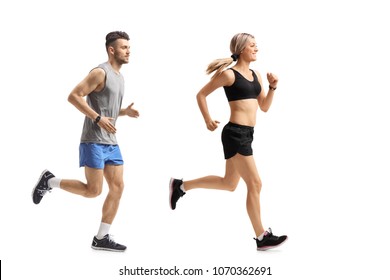 Full length profile shot of a young man and a young woman running isolated on white background