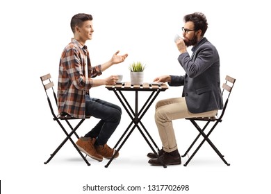 Full Length Profile Shot Of A Young Guy In A Cafe Talking To A Bearded Man Drinking Coffee Isolated On White Background