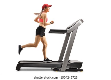 Full Length Profile Shot Of A Young Woman Running On A Treadmill Isolated On White Background