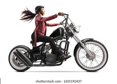 Full length profile shot of a young woman riding a custom black motorcycle isolated on white background - Shutterstock ID 1655192437
