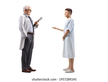 Full Length Profile Shot Of A Young Male Patient Talking To A Mature Male Doctor Isolated On A White Background