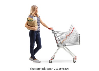 Full Length Profile Shot A Young Woman With A Shopping Cart With Bar Chart And A Paper Bag Isolated On White Background