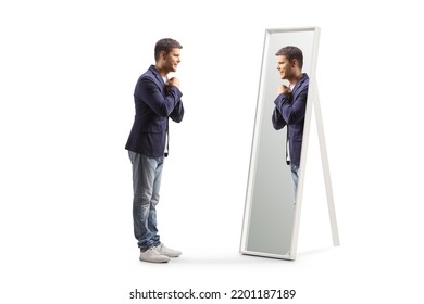 Largo perfil de un joven preparado mirando un espejo aislado en fondo blanco
