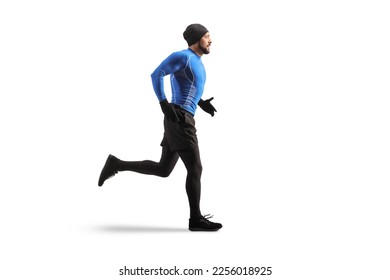 Full length profile shot of a young fit man running in warm clothes isolated on white background - Shutterstock ID 2256018925