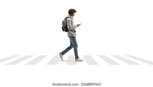 Full length profile shot of a young african american man using a phone and crossing street isolated on white background - Shutterstock ID 2268809563