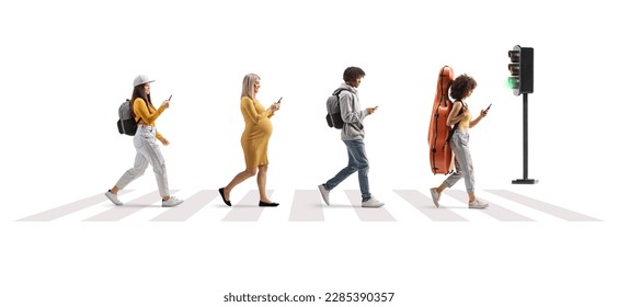 Full length profile shot of young people crossing street at a pedestrian crossing and using mobile phones isolated on white background - Shutterstock ID 2285390357